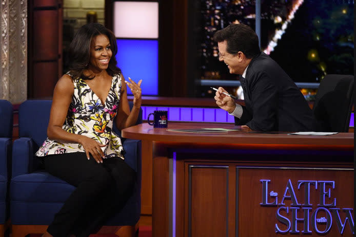 Michelle Obama talking with Stephen Colbert on the “Late Show” wearing a floral peplum top.