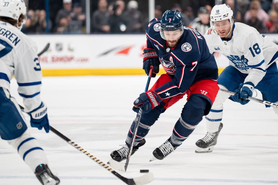 Dec 23, 2023; Columbus, Ohio, USA;
Columbus Blue Jackets center Sean Kuraly (7) brings the puck down the rink against Toronto Maple Leafs defenseman Timothy Liljegren (37) and center Noah Gregor (18) during the first period of their game on Saturday, Dec. 23, 2023 at Nationwide Arena.