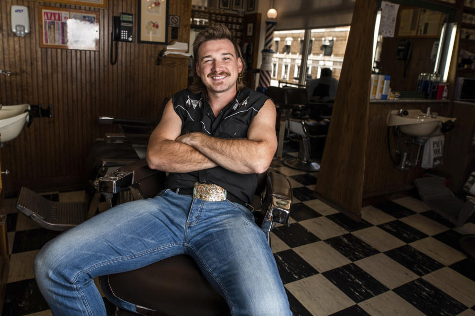FILE - In this Aug. 27, 2019 file photo, Country singer Morgan Wallen poses for a portrait after getting a mullet at Paul Mole Barber Shop on , in New York. Wallen wasn’t allowed to compete at this month’s Academy of Country Music Awards because the singer was caught on camera using a racial slur earlier this year, but he’s one of the top nominees at the 2021 Billboard Awards. (Photo by Charles Sykes/Invision/AP, File)