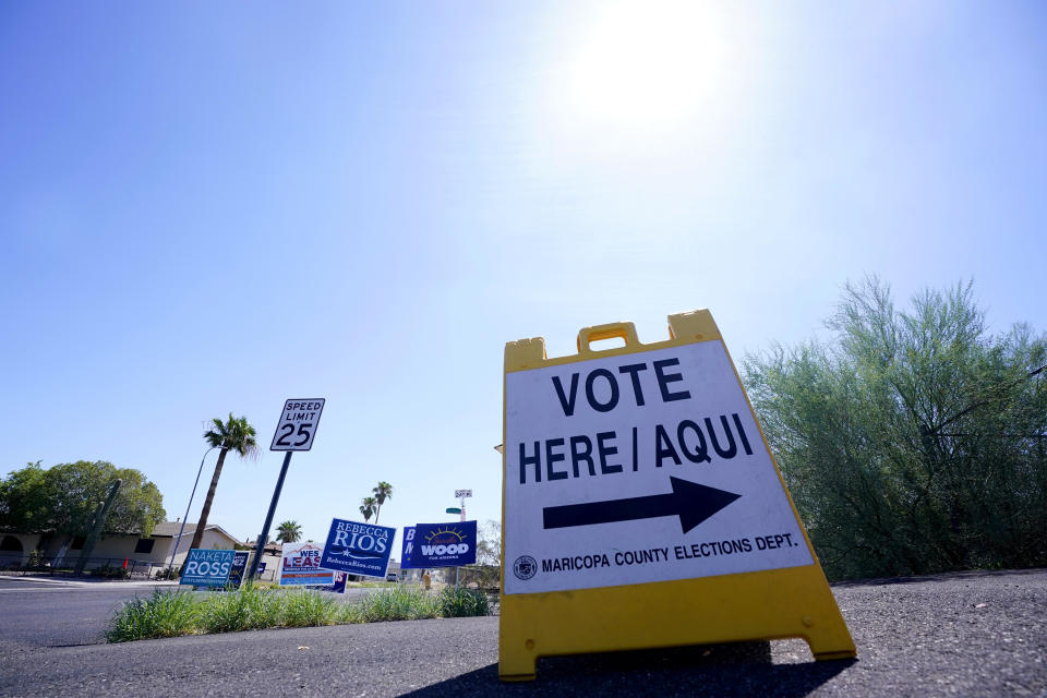 A where to vote sign points voters in the direction of the polling station as the sun beats down as Arizona voters go the polls to cast their ballots, Tuesday, Aug. 2, 2022, in Phoenix. (AP Photo/Ross D. Franklin)