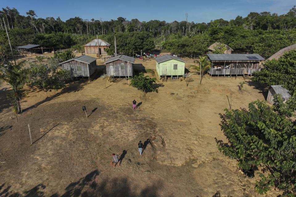 Members of the Juma Indigenous community, where three sisters lead and manage the Indigenous territory after the death of their father in 2021, work near Canutama, Amazonas state, Brazil, Saturday, July 8, 2023. (AP Photo/Andre Penner)