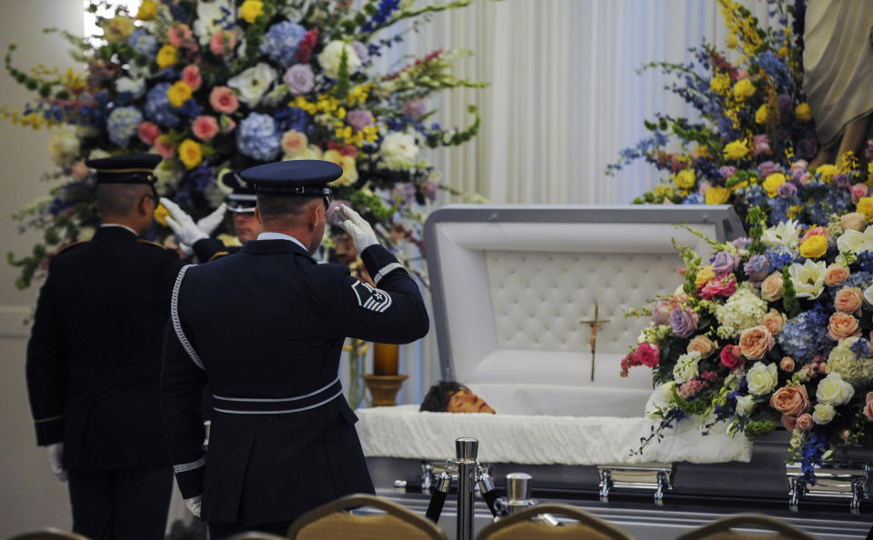 Honor guard members salute the casket of former Louisiana Gov. Kathleen Blanco during a visitation at St. John's Cathedral Hall, Friday, Aug. 23, 2019, in Lafayette, La. Blanco, who served one term as governor and various elected positions across two decades, was in Louisiana’s top job during the destruction of hurricanes Katrina and Rita in 2005. She died a week earlier from cancer. (Brad Kemp/The Advocate via AP)