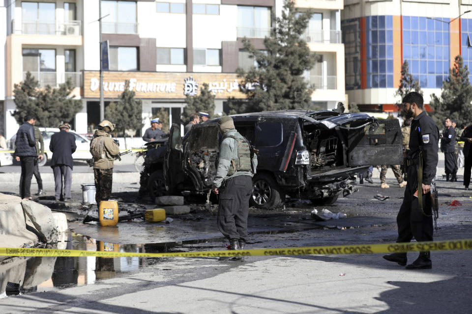 Security personnel inspect the site of a deadly bomb attack in Kabul, Afghanistan, Wednesday, Feb. 10, 2021. (AP Photo/Rahmat Gul)