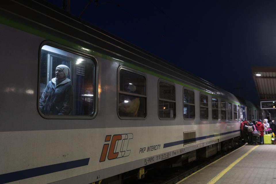 FILE - Ukrainian refugees embark a train bound to Warsaw, at the Przemysl train station, southeastern Poland, on March 11, 2022. Railway authorities in Poland and Italy say that major malfunctions of the electronic control systems have caused significant delays and cancellations of train connections in the two countries. In Poland, government official in charge of cybersecurity, Janusz Cieszynski, said a team for Critical Incidents will hold a meeting Thursday to analyze the outage. (AP Photo/Petros Giannakouris, File)
