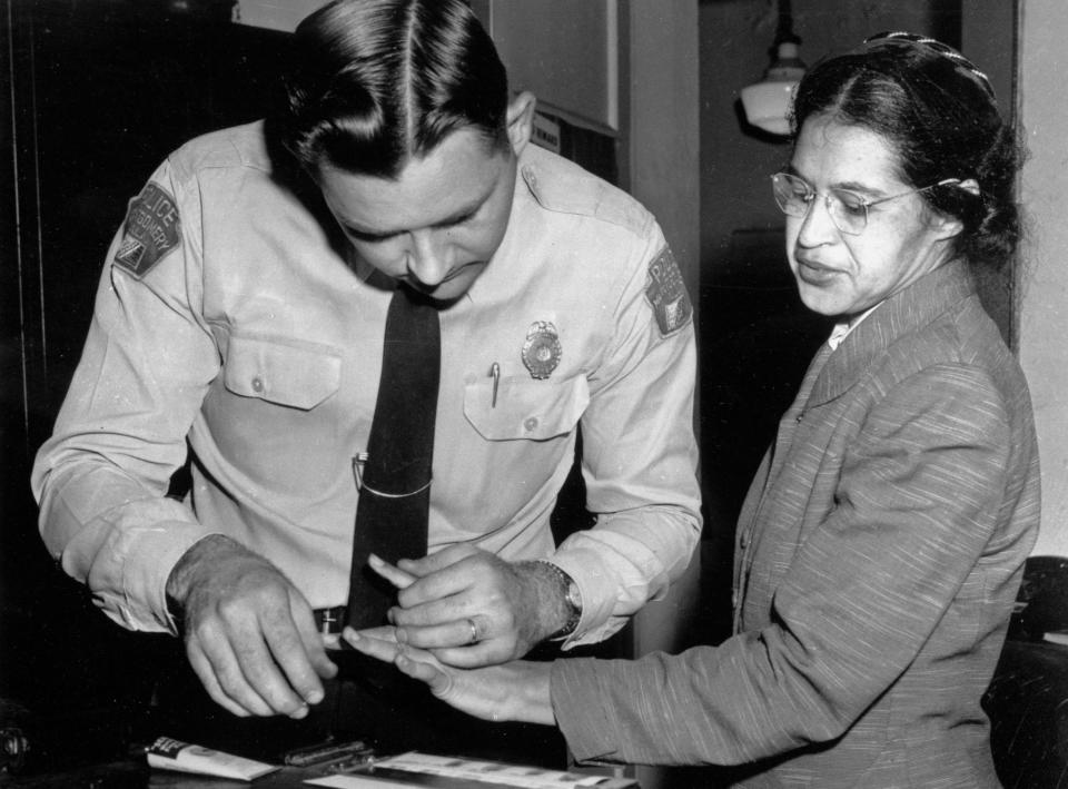 FILE - In this Feb. 22, 1956, file photo, Rosa Parks is fingerprinted by police Lt. D.H. Lackey in Montgomery, Ala., after refusing to give up her seat on a bus for a white passenger on Dec. 1, 1955. Yellowing court records from the arrests of Rosa Parks, Martin Luther King Jr. and others at the dawn of the modern civil rights era are being preserved and digitized after being discovered, folded and wrapped in rubber bands, in a courthouse box. (AP Photo/Gene Herrick, File)