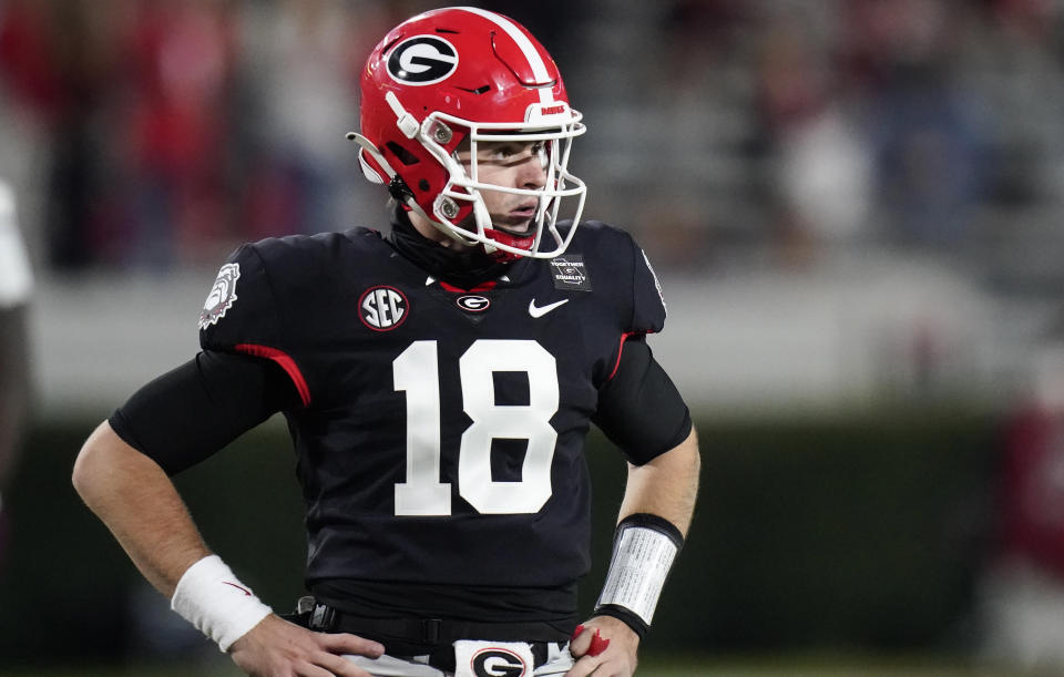 Georgia quarterback JT Daniels looks for a play call from the sideline during the first half of the team's NCAA college football game against Mississippi State, Saturday, Nov. 21, 2020, in Athens, Ga. (AP Photo/Brynn Anderson)