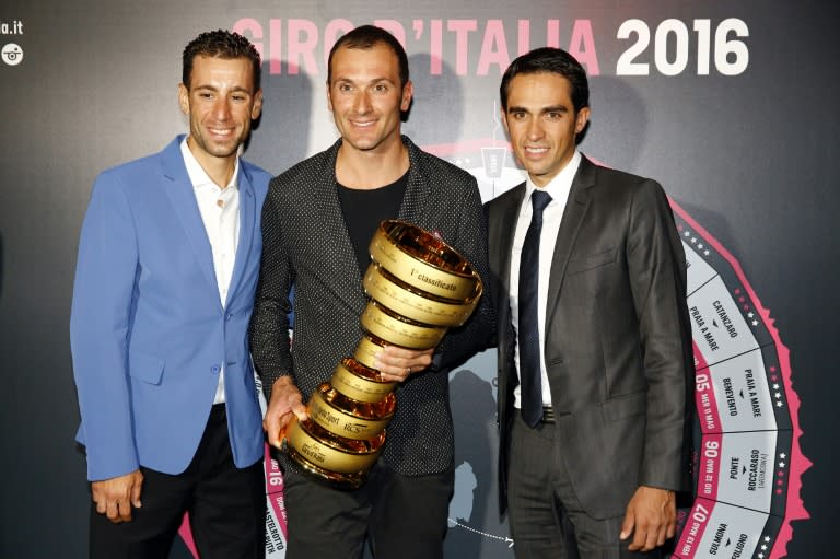 From L: Riders Vincenzo Nibali of Italy, Ivan Basso of Italy and Alberto Contador of Spain pose with the trophy of the Giro d'Italia during the presentation of the 2016 cycling race, on October 5, 2015 in Milan