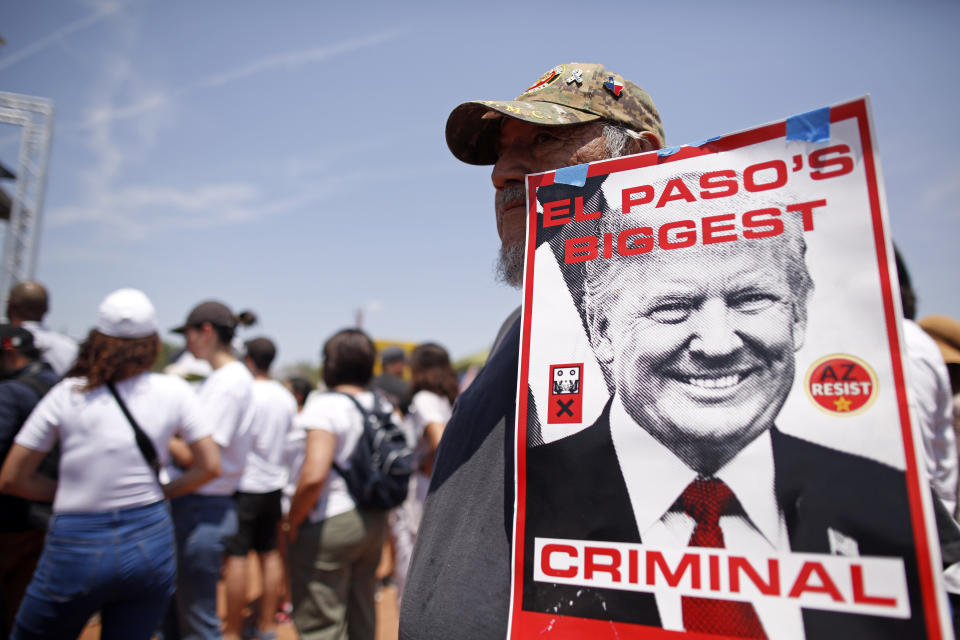 FILE- In this Aug. 7, 2019, file photo, Fernie Bermudez holds a sign to protest the visit of President Donald Trump to the border city after mass shooting in El Paso, Texas, that claimed the lives of mostly Hispanic victims. A new poll by The Associated Press-NORC Center for Public Affairs Research finds about half of Americans think Donald Trump's actions as president have made things worse for African Americans, Muslims and women. (AP Photo/Andres Leighton, File)