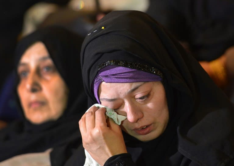 The Pakistani mother of a student killed during a 2014 attack on a school in Peshawar grieves during a memorial service in Peshawar