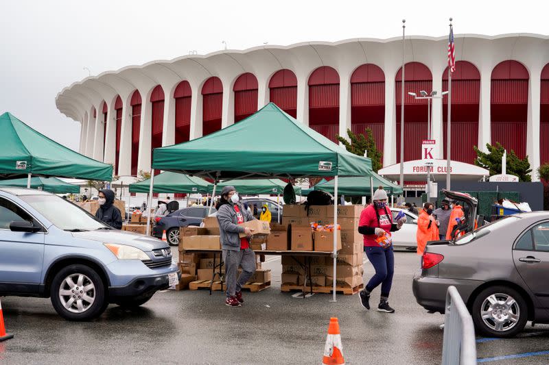 Volunteers with Los Angeles County Federation of Labor, AFL-CIO, hand out boxes of food to LAX workers in the parking lot of The Forum during the outbreak of the coronavirus disease (COVID-19), in Inglewood