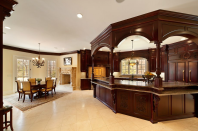 The kitchen includes a family dining area. It's outfitted with "two of everything," <a href="http://bit.ly/PYgou2" rel="nofollow noopener" target="_blank" data-ylk="slk:Graves says;elm:context_link;itc:0;sec:content-canvas" class="link ">Graves says</a>: "Any master chef could bring his team in and use it efficiently." The wood is hand-carved cherry, custom-built for the house.