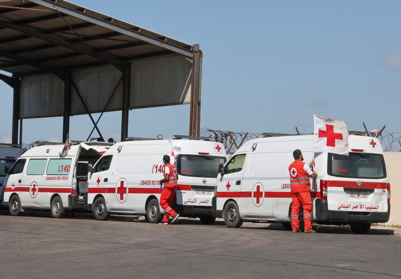 Lebanese Red Cross vehicles are parked at the Lebanese-Syrian border crossing in Arida