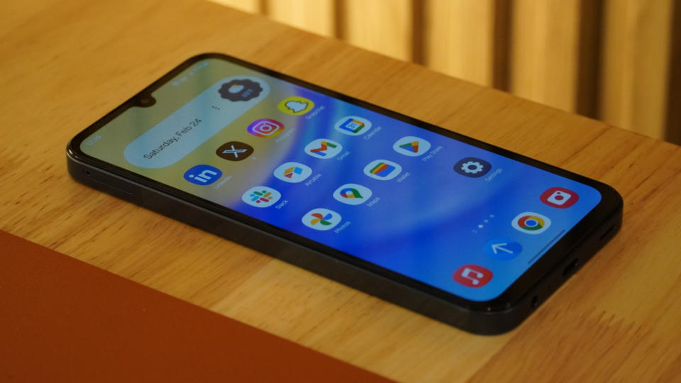 The home screen on a Samsung Galaxy A15 5G on a desk.