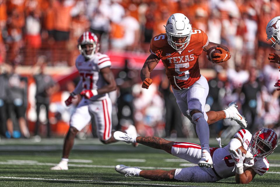 Texas running back Bijan Robinson jumps over a Louisiana defender during the Longhorns' 38-18 season-opening win last year at Royal-Memorial Stadium. Robinson is expected to be one of the nation's top backs this year.