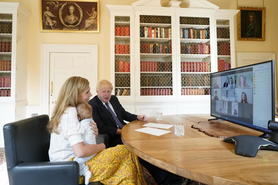 The Prime Minister Boris Johnson and his partner Carrie Symonds with their son Wilfred in the study of No. 10 Downing Street speaking via zoom to the midwifes that helped deliver their son at the UCLH. (Andrew Parsons/No10 Downing St)