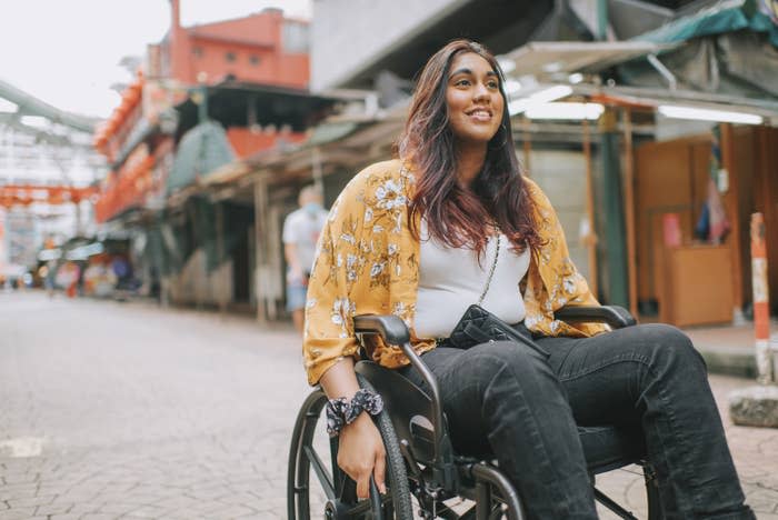 A woman in a wheelchair outside