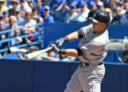 Aug 15, 2015; Toronto, Ontario, CAN; New York Yankees right fielder Carlos Beltran (36) hits a home run against Toronto Blue Jays in the first inning at Rogers Centre. Dan Hamilton-USA TODAY Sports