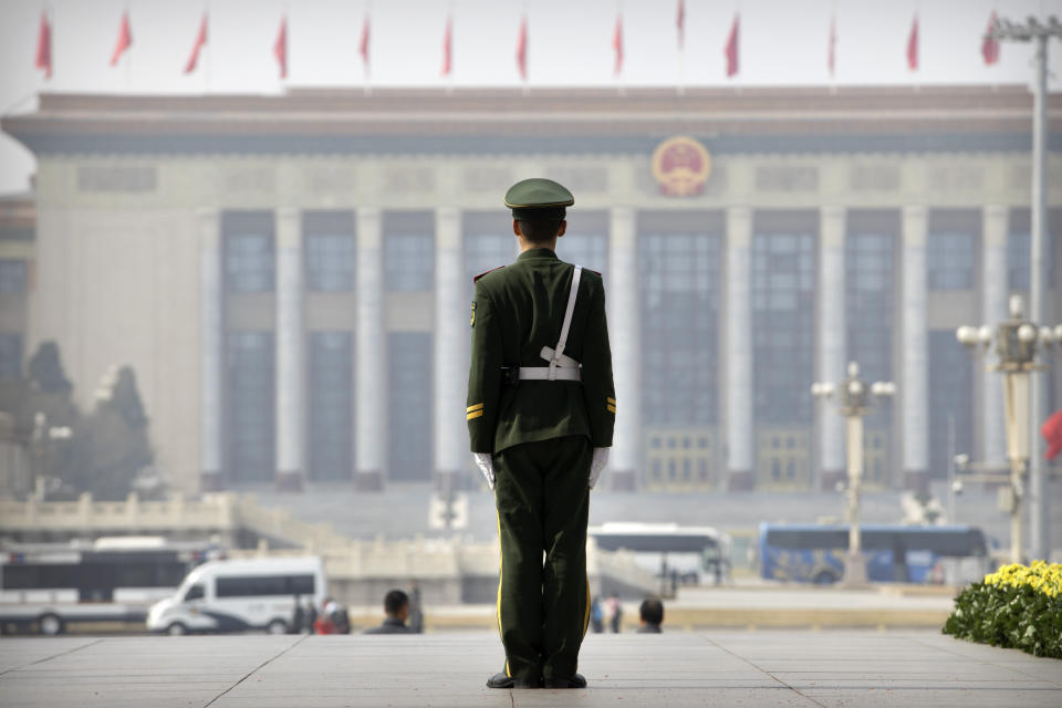 A Chinese paramilitary policeman stands guard while facing the Great Hall of the People, the meeting place of China's national legislature, in Beijing, Friday, March 1, 2019. Thousands of delegates from around China are gathering in Beijing for next week's annual session of the country's rubber-stamp legislature and its advisory body. (AP Photo/Mark Schiefelbein)