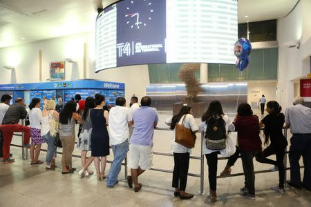 FILE PHOTO: People wait at the arrival hall at Terminal 4 of JFK airport after U.S. President Donald Trump's limited travel ban was approved by the U.S. Supreme Court, in New York City, U.S., June 29, 2017. REUTERS/Joe Penney