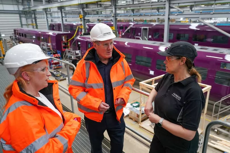 Keir Starmer, Leader of the Labour Party and Labour's Shadow Transport Secretary Louise Haigh (L) speak to a member of staff as they visit Hitachi Rail on April 25, 2024 in Newton Aycliffe