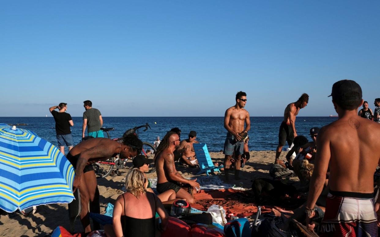 People enjoy the sunny weather at Barceloneta beach, Spain -  Nacho Doce / Reuters