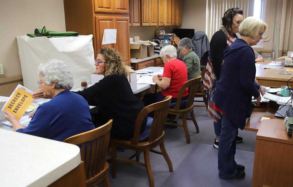 Des Moines County Auditor Terri Johnson, right, leads workers and volunteers in the counting of the midterm election absentee ballots for the county Tuesday, Nov. 8, 2022, at the county courthouse in Burlington. There were six volunteers working in teams of two with a Republican and Democratic party member on each team counting the more than 4,000 absentee ballots.