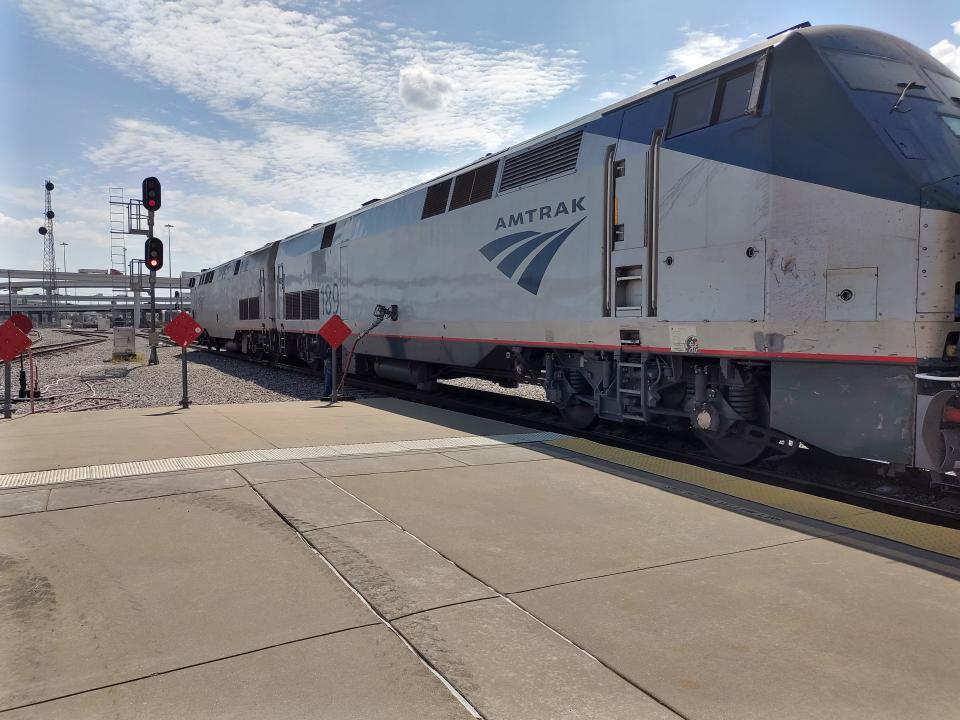 exterior shot of an amtrak train stopped at a station