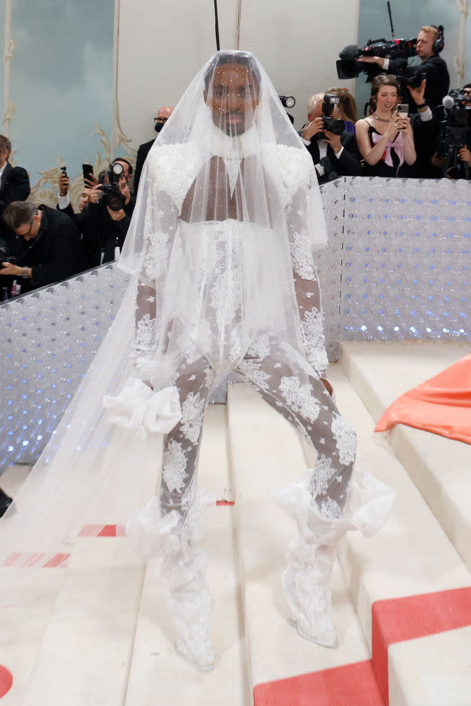 Alton on the Met Gala stairs in a lacy outfit and wearing a bridal veil