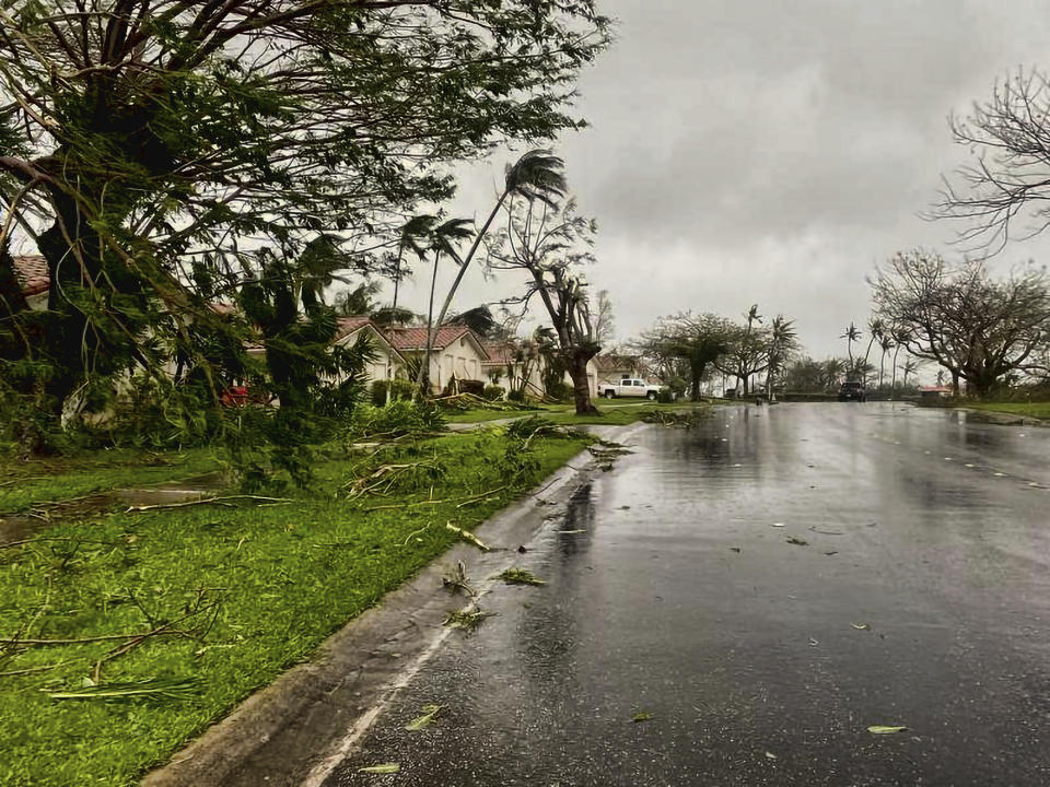 In this photo provided by the U.S. Coast Guard, downed tree branches litter a neighborhood in Yona, Guam, Thursday, May 25, 2023, after Typhoon Mawar passed over the island. The powerful typhoon smashed the U.S. territory of Guam and continued lashing the Pacific island with high winds and heavy rain Thursday, knocking down trees, walls and power lines and creating a powerful storm surge that threatened to wash out low-lying areas. (Chief Warrant Officer Adam Brown/U.S. Coast Guard via AP)