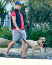 <p>Jon Hamm wears a vest, shorts and flip flops while out walking his dog in L.A. on Wednesday.</p>