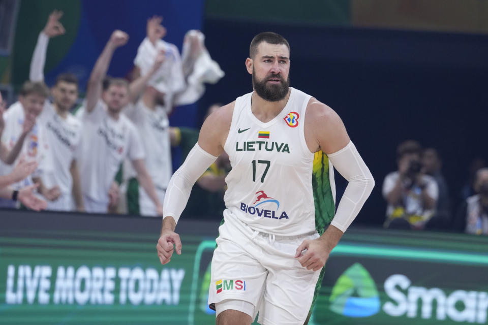Lithuania center Jonas Valanciunas (17) reacts during the Basketball World Cup quarterfinal game between Lithuania and Serbia at the Mall of Asia Arena in Manila, Philippines, Tuesday, Sept. 5, 2023. (AP Photo/Michael Conroy)