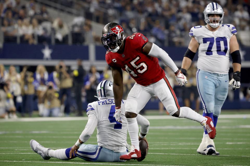 Tampa Bay Buccaneers linebacker Devin White (45) celebrates after sacking Dallas Cowboys quarterback Dak Prescott (4) as guard Zack Martin (70) walks past in the second half of a NFL football game in Arlington, Texas, Sunday, Sept. 11, 2022. (AP Photo/Michael Ainsworth)