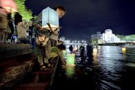 <p>People attend the Peace Message Lantern Floating Ceremony held to console the souls of the A-Bomb victims after the Hiroshima Peace Memorial Ceremony at the Hiroshima Peace Memorial Park on the occasion of the 72nd anniversary of Hiroshima atomic bombing on Aug. 6, 2017 in Hiroshima, Japan. (Photo: David Mareuil/Anadolu Agency/Getty Images) </p>