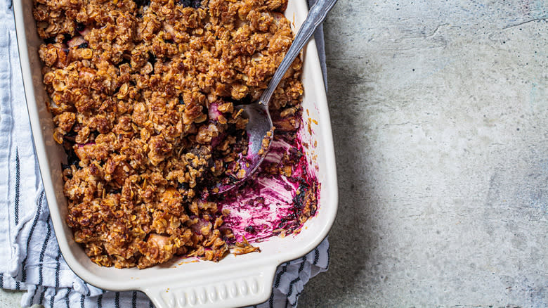 berry crisp in pan with spoon