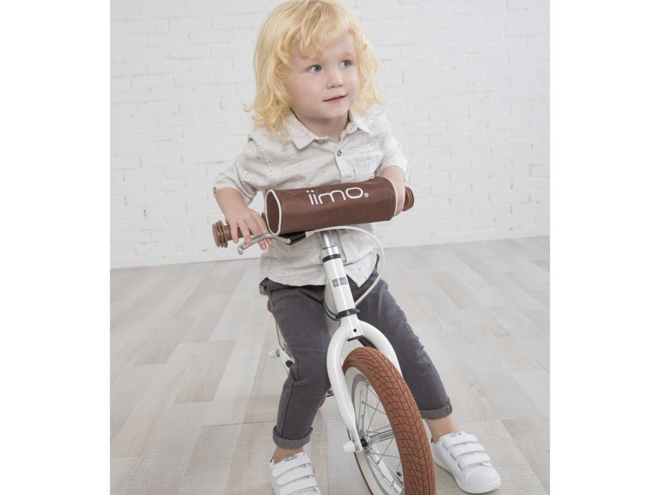 Child riding balance bike