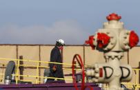 FILE - This March 25, 2014 file photo shows heat from machinery distorts the air as a worker watches over a hydraulic fracturing operation at an Encana Corp. gas well near Mead, Colo. The energy boom is scrambling national politics. Democrats are split between environmentalists and business and labor groups. Some deeply-conservative areas are allying with conservationists against fracking, the technique largely responsible for the surge. (AP Photo/Brennan Linsley, File)