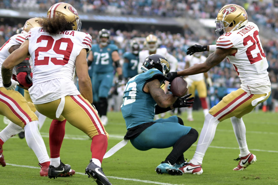 Jacksonville Jaguars wide receiver Christian Kirk (13) fumbles, with the ball being recover by San Francisco 49ers cornerback Ambry Thomas (20) during the second half of an NFL football game, Sunday, Nov. 12, 2023, in Jacksonville, Fla. (AP Photo/Phelan M. Ebenhack)