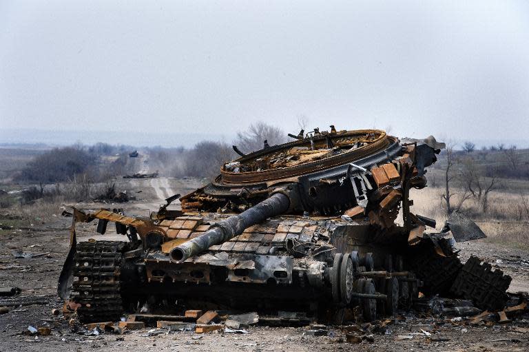 A destroyed tank sits on a road near the town of Debaltseve, eastern Ukraine on March 26, 2015