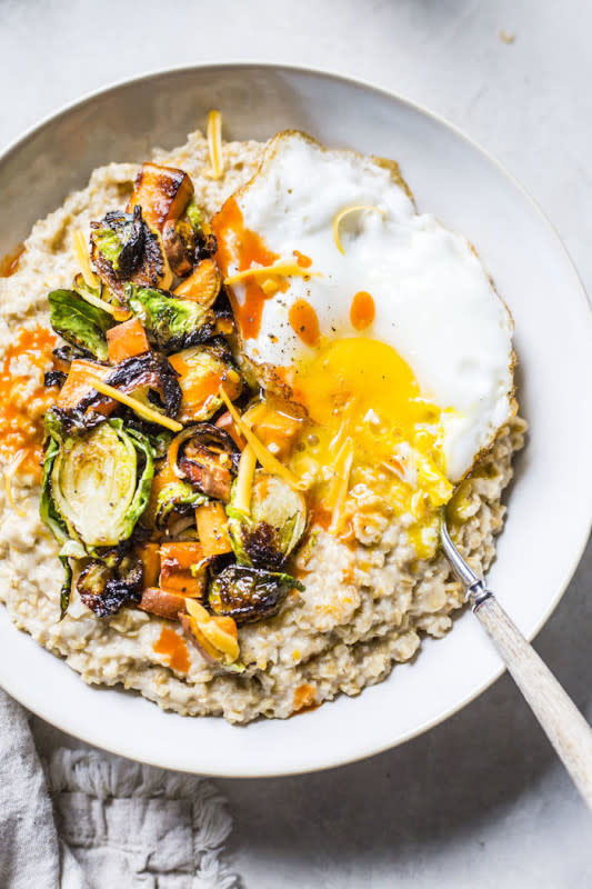 <p>The Almond Eater</p><p>This cheesy savory oatmeal is made with cheddar cheese and topped with brussels sprouts, sweet potatoes, a fried egg and hot sauce for extra flavor. </p><p><strong>Get the recipe: <a href="https://thealmondeater.com/cheesy-savory-oatmeal-breakfast-bowl/" rel="nofollow noopener" target="_blank" data-ylk="slk:Cheesy Savory Oatmeal Breakfast Bowl;elm:context_link;itc:0;sec:content-canvas" class="link ">Cheesy Savory Oatmeal Breakfast Bowl</a></strong></p>