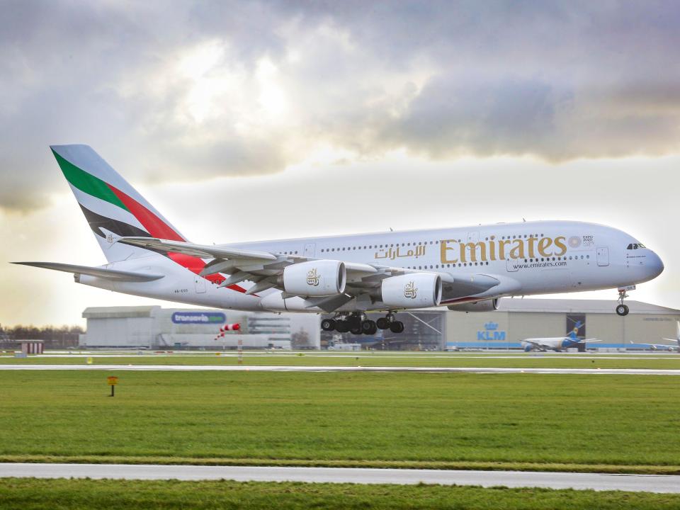 An Emirates airplane, the double-decker Airbus A380 with registration A6-EOO is approaching Amsterdam Schiphol International Airport arriving at runway 27