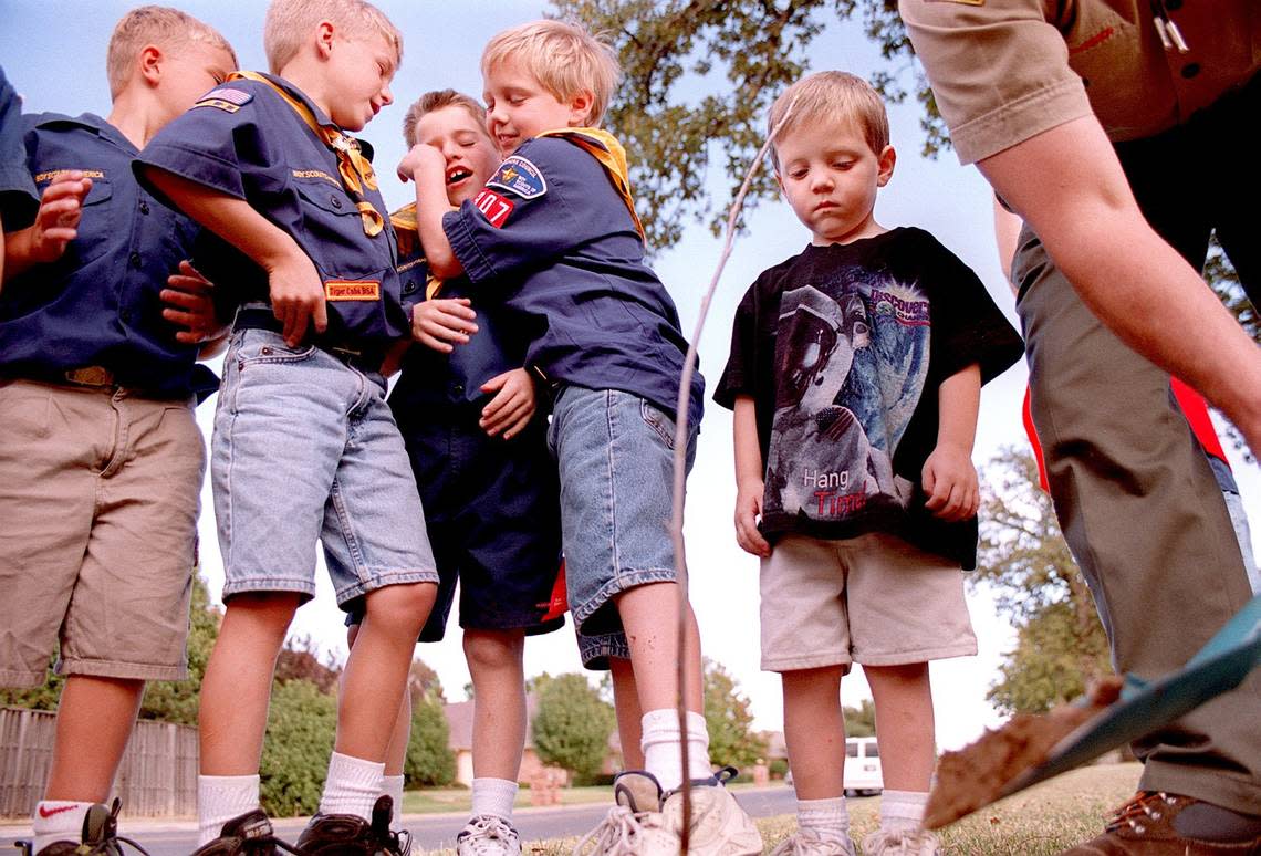 Oct. 27, 1999: Cullen Shipp, 3, watches as Jonathan Masterson shovels extra dirt onto a tree planted by members of Boy Scouts Den 3 Pack 307. The tree was planted in front of Spring Garden Elementary in Bedford. Paul Zoeller/SPECIAL TO THE STAR-TELEGRAM