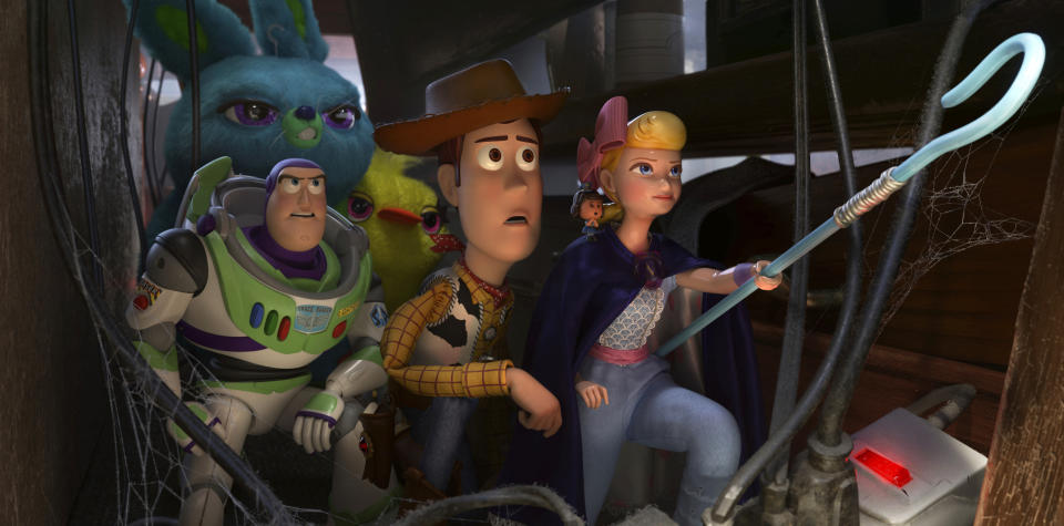 This image released by Disney shows, foreground from left, Buzz Lightyear, voiced by Tim Allen, Woody, voiced by Tom Hanks and Bo Peep, voiced by Annie Potts in a scene from "Toy Story 4."(Disney/Pixar via AP)
