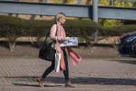 People leaving the headquarters of tour operator Thomas Cook, in Peterborough, England, which has ceased trading with immediate effect after failing in a final bid to secure a rescue package from creditors Monday Sept. 23, 2019. British tour company Thomas Cook collapsed early Monday after failing to secure emergency funding, leaving tens of thousands of vacationers stranded abroad. The British government said the return of the 178-year-old firm's 150,000 British customers now in vacation spots across the globe would be the largest repatriation in its peacetime history. (Joe Giddens/PA via AP)