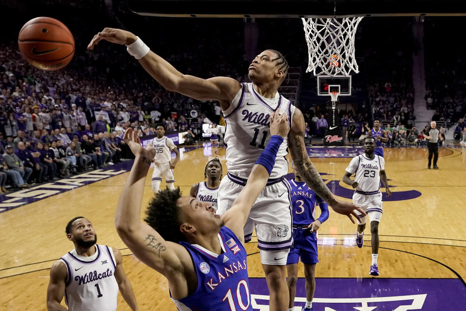 Kansas State forward Keyontae Johnson (11) blocks a shot by Kansas forward Jalen Wilson (10) during the first half of an NCAA college basketball game Tuesday, Jan. 17, 2023, in Manhattan, Kan. (AP Photo/Charlie Riedel)