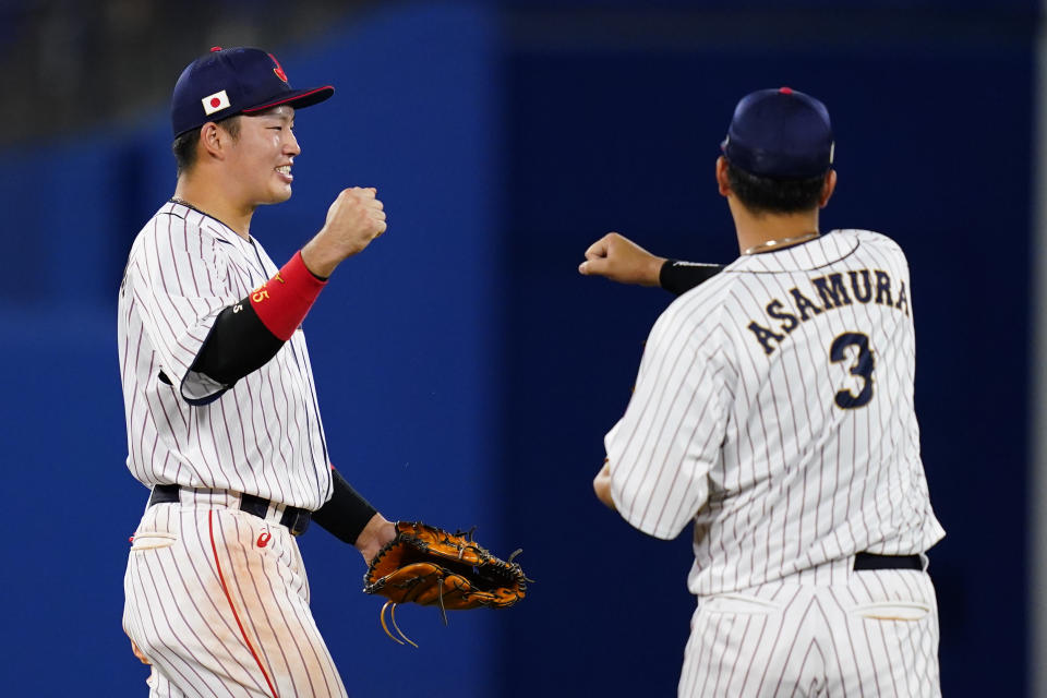 Japan's Munetaka Murakami, left, and Hideto Asamura celebrate after a semi-final baseball game against South Korea at the 2020 Summer Olympics, Wednesday, Aug. 4, 2021, in Yokohama, Japan. Japan won 5-2. (AP Photo/Matt Slocum)