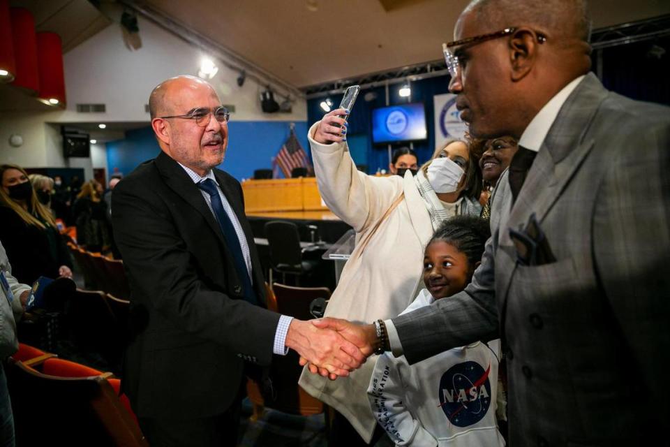 Jose Dotres, left, is congratulated by Miami-Dade School Board Vice Chair Steve Gallon III after being selected by the board as the next superintendent in a 6-3 vote late Monday during a special meeting at the board’s headquarters in downtown Miami. Dotres, who is deputy superintendent of Collier County Public Schools, was one of three finalist applying for the position of superintendent. He will replace Alberto Carvalho. Before going over to Collier County, he was a longtime employee of Miami-Dade Public Schools.