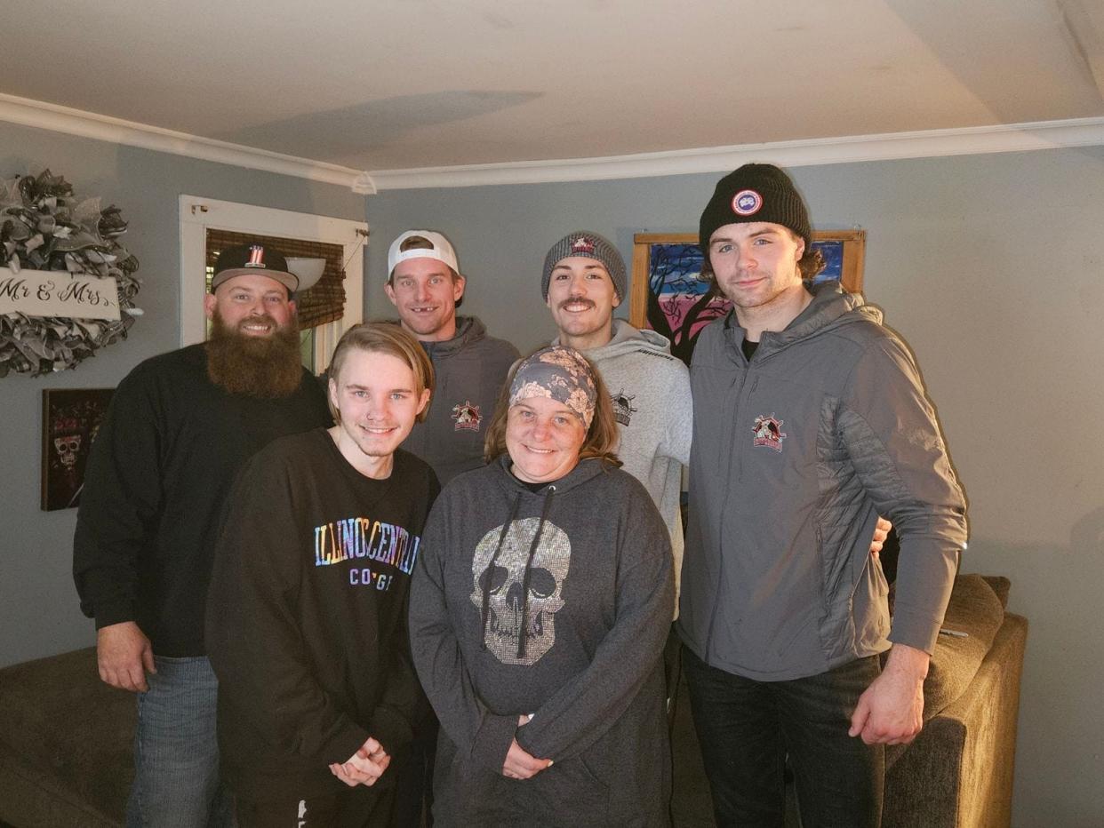 Alisa Pederson-Davis with her son, Kolten, and husband, Dewy (far left) during a visit at their Washington home by Rivermen players Alec Hagaman (back row second left), Zach Wilkie (back row second right) and Tristan Trudel (back row far right) during the season.