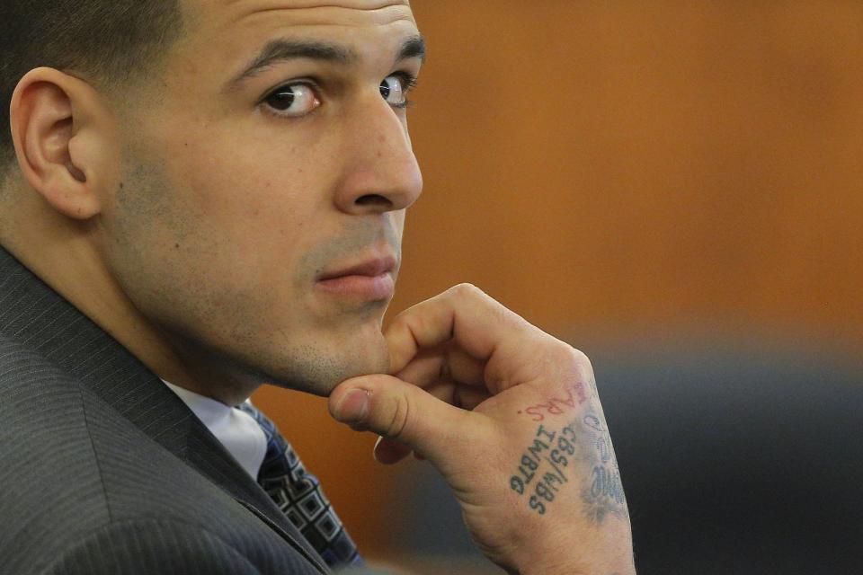 Former New England Patriots football player Aaron Hernandez listens as prosecution witness Alexander Bradley testifies at Bristol County Superior Court in Fall River, Massachusetts April 1, 2015. Bradley, a former friend of Hernandez, testified on Wednesday that he saw the ex-New England Patriots player handle a gun similar to the one prosecutors contend he used to murder an acquaintance, and that Hernandez had a distrustful nature. Hernandez, 25, is charged with killing Odin Lloyd, who was dating his fiancee's sister. REUTERS/Brian Snyder