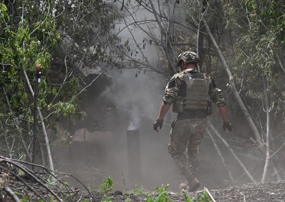 Ukrainian artillerymen fire a gun toward Russian positions near Avdiivka in the Donetsk region in June (AFP via Getty Images)