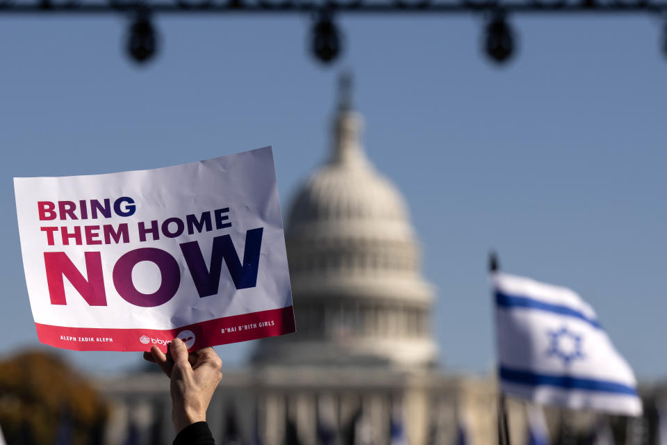 A person holds up a sign that reads 